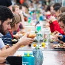 Hundreds of members from the Appalachian and local communities enjoy a sustainable meal of salad, baked potatoes and apple pie during the 2018 Community FEaST held on Appalachian’s Sanford Mall. The event is designed to bring people from all walks of life together to engage in conversations about the importance of a sustainable food system for all. Photo by Marie Freeman