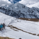 With Ausangate Mountain looming large in the background, Dr. Baker Perry and his research group traverse a trail from the Jampa Pass, at an elevation of about 16,400 feet. Local Peruvians consider the mountain to be sacred. Photo by Marie Freeman