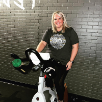 Lauren Stansberry, administrative support specialist, Dean’s Office, completing her 100th ride at Revolution Boone. Photo submitted
