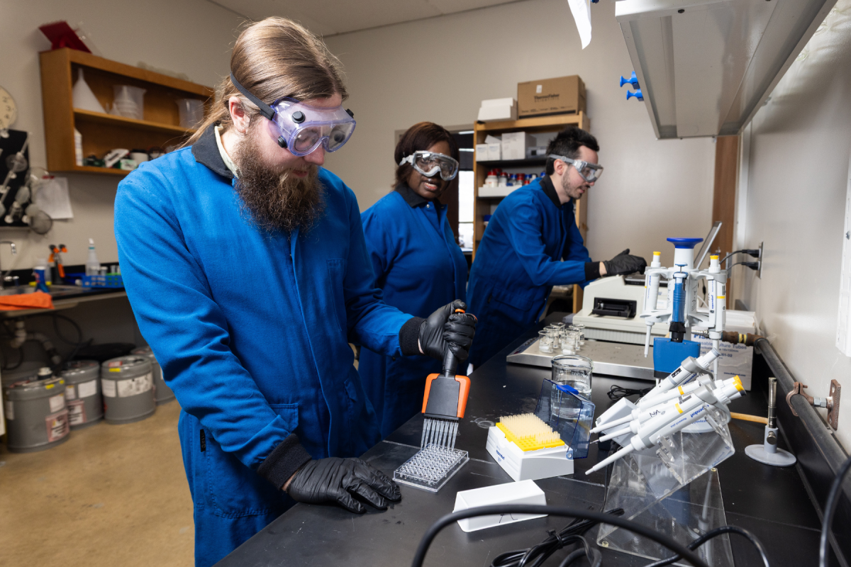 From left, Jackson Johnson, Dr. Nancy Asen, and Jack Kelly work in the lab. Photo by Chase Reynolds