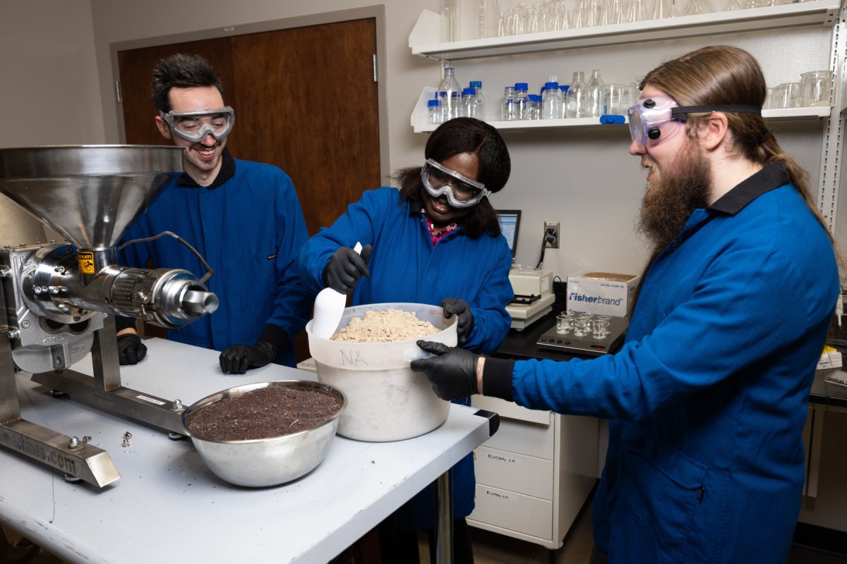 App State student researchers Jack Kelly, left, and Jackson Johnson, right, prepare oil seed waste for analysis in a project led by Dr. Nancy Asen, center, using fermentation to turn waste to food. Photo by Chase Reynolds