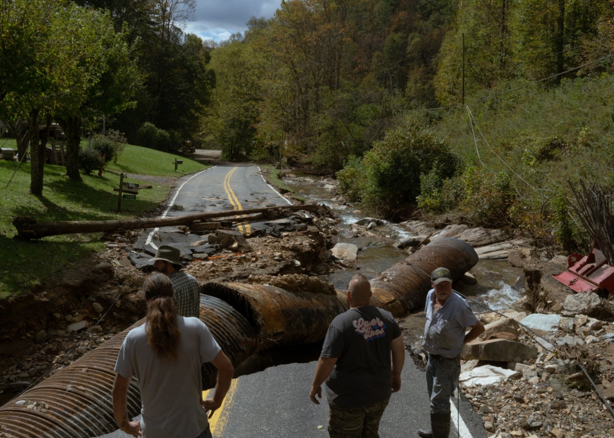 Supply runners check out a washed out road in Ashe County. Photo by Barber (jesse-barber.com)