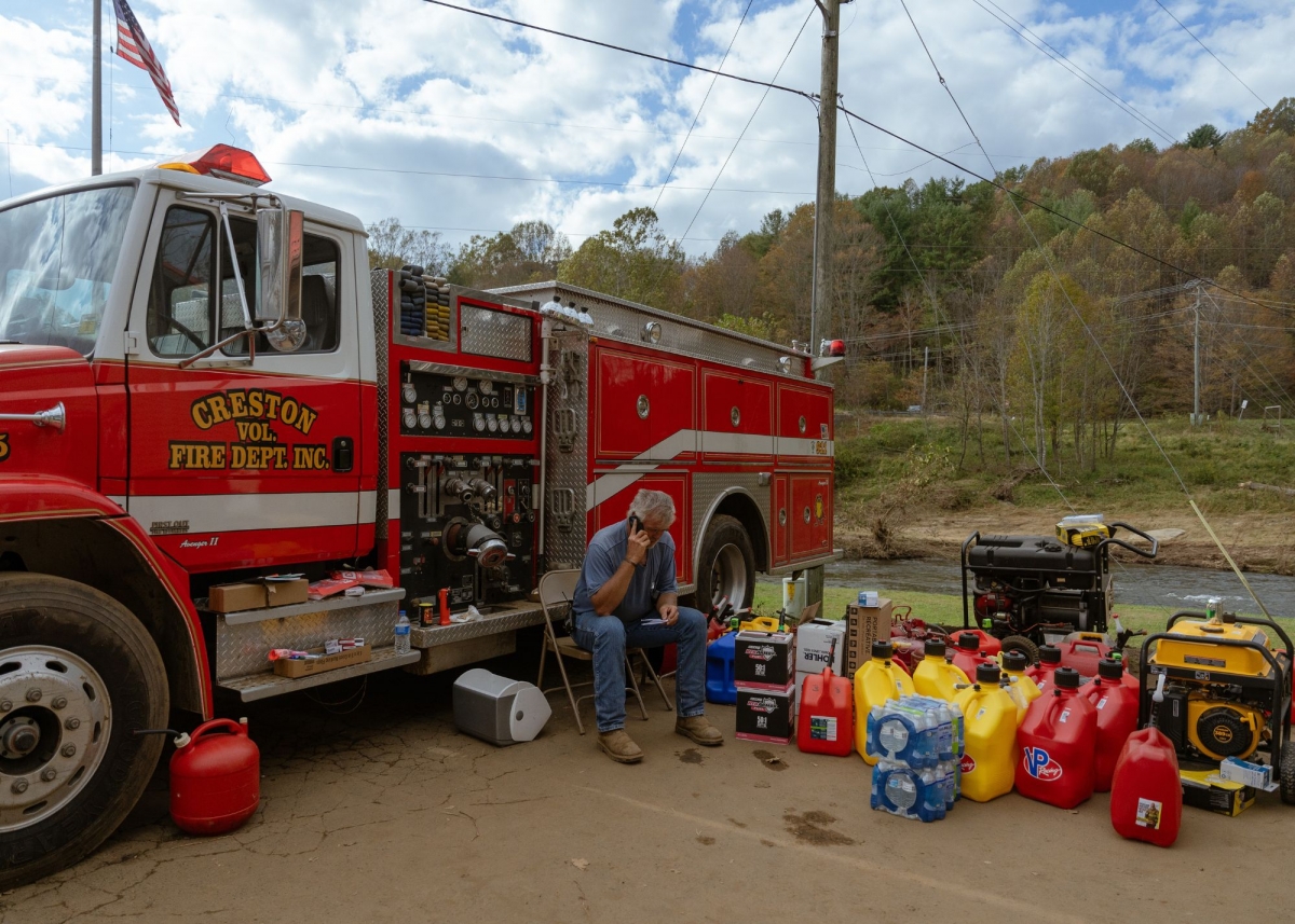 Junior Seatz, the fire chief of Creston Fire Department, in Creston, NC, on October 3. All day for the past eight days, Junior has been standing in this spot answering a barrage of questions, giving directions, keeping lists of items needed, sending crews out to specific communities in need, answering his phone and radio and trying to get a bite to eat somewhere in between. Photo by Barber (jesse-barber.com)