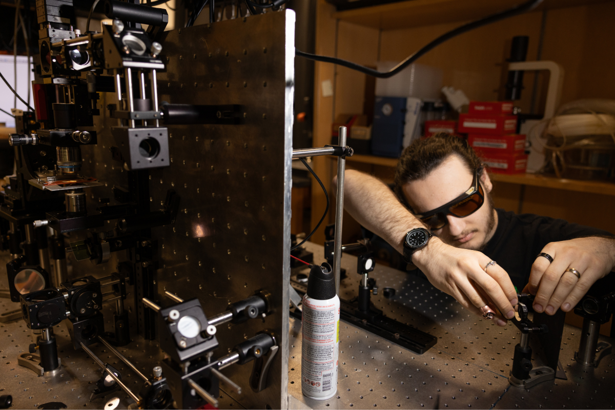Junior physics major Joshua Lennon, of Greensboro, optimizes the spectrometer in the Laser Tweezers Raman Spectroscopy system. Photo by Chase Reynolds