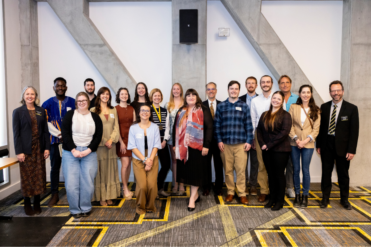 Cratis D. Williams School of Graduate Studies Dean Ashley Colquitt, far left, and Associate Dean Ross Gosky, far right, stand with 2025&ndash;26 award recipients at the Faculty and Student Awards Ceremony on Tuesday, April 7, 2026. (Photo by Kyla Willoughby)