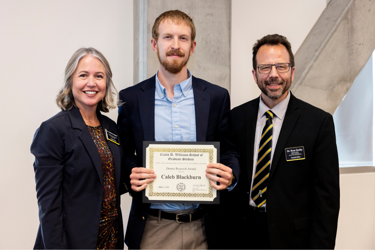 Geography graduate student Caleb Blackburn &rsquo;21, center, receives the Domer Research Award at the Cratis D. Williams School of Graduate Studies Faculty and Student Awards Ceremony on Tuesday, April 7, 2026. (Photo by Kyla Willoughby)