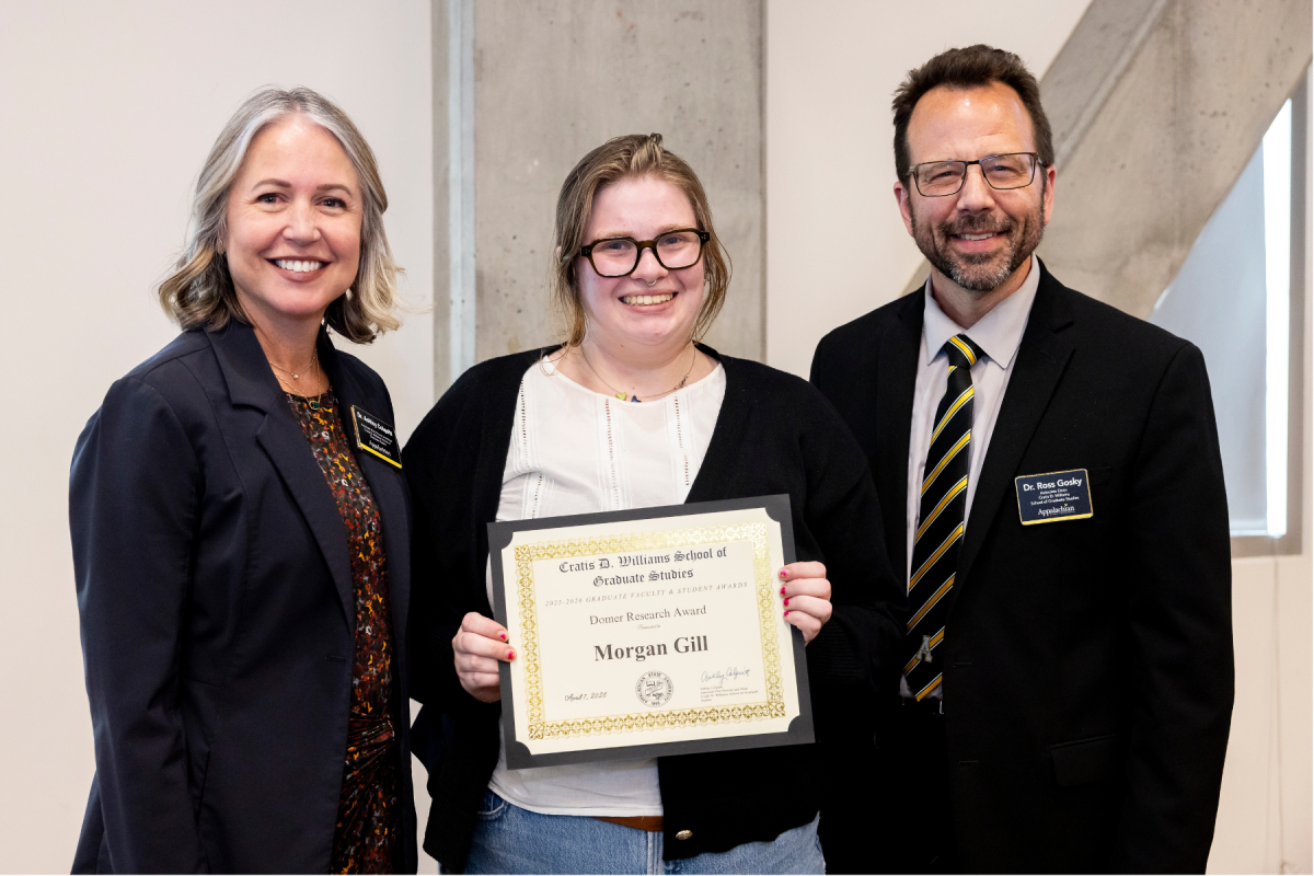 Biology graduate student Morgan Gill &rsquo;24, center, receives the Domer Research Award at the Cratis D. Williams School of Graduate Studies Faculty and Student Awards Ceremony on Tuesday, April 7, 2026. (Photo by Kyla Willoughby)
