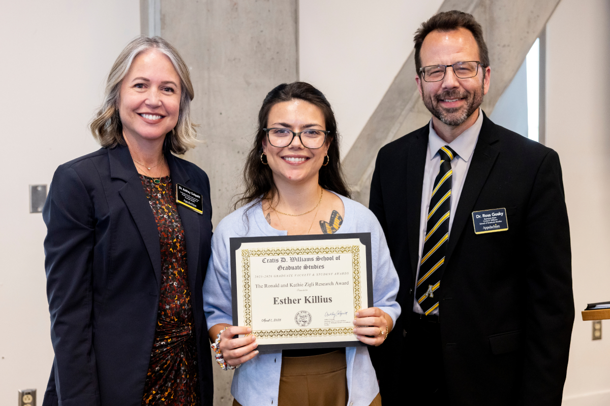 Esther Killius &rsquo;19, center, graduate student in the Doctor of Psychology in Clinical Psychology program, receives the Zigli Research Award at the Cratis D. Williams School of Graduate Studies Faculty and Student Awards Ceremony on Tuesday, April 7, 2026. (Photo by Kyla Willoughby)