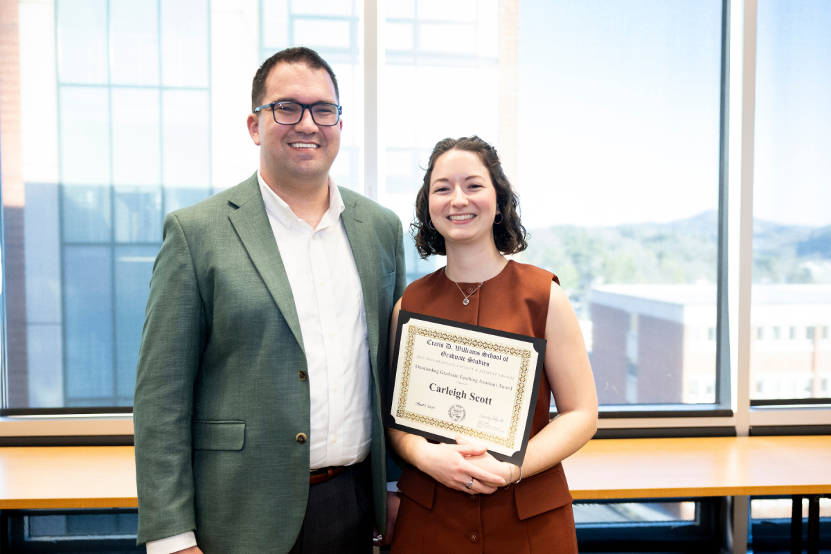 Dr. Quinn Morris, left, associate professor and graduate program director in the Department of Mathematical Sciences, celebrates with Carleigh Scott &rsquo;22, right, recipient of the Outstanding Graduate Teaching Assistant Award, at the Cratis D. Williams School of Graduate Studies Faculty and Student Awards Ceremony on Tuesday, April 7, 2026. (Photo by Kyla Willoughby)