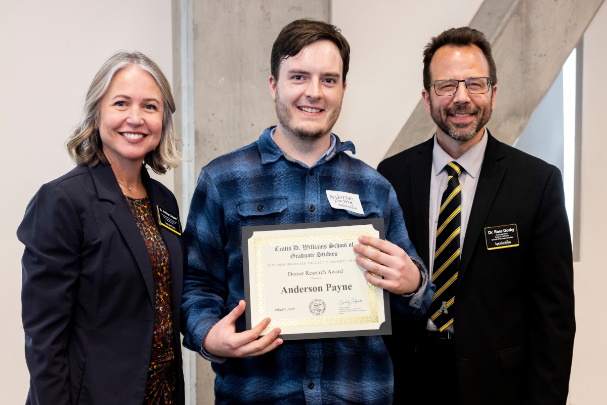 Biology graduate student Anderson Payne, center, receives the Domer Research Award at the Cratis D. Williams School of Graduate Studies Faculty and Student Awards Ceremony on Tuesday, April 7, 2026. (Photo by Kyla Willoughby)