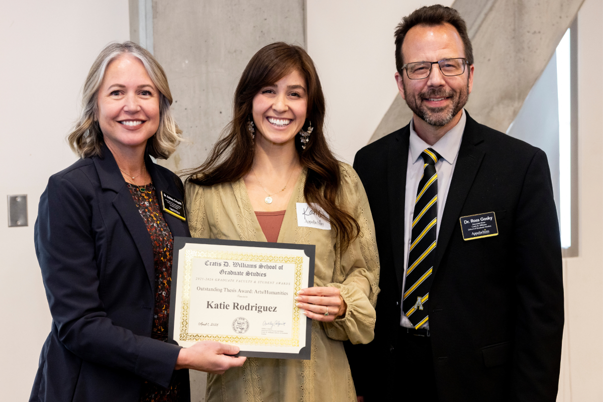 Appalachian studies alumna Katie Rodriguez &rsquo;25, center, receives the Outstanding Thesis Award in the arts and humanities category at the Cratis D. Williams School of Graduate Studies Faculty and Student Awards Ceremony on Tuesday, April 7, 2026. (Photo by Kyla Willoughby)