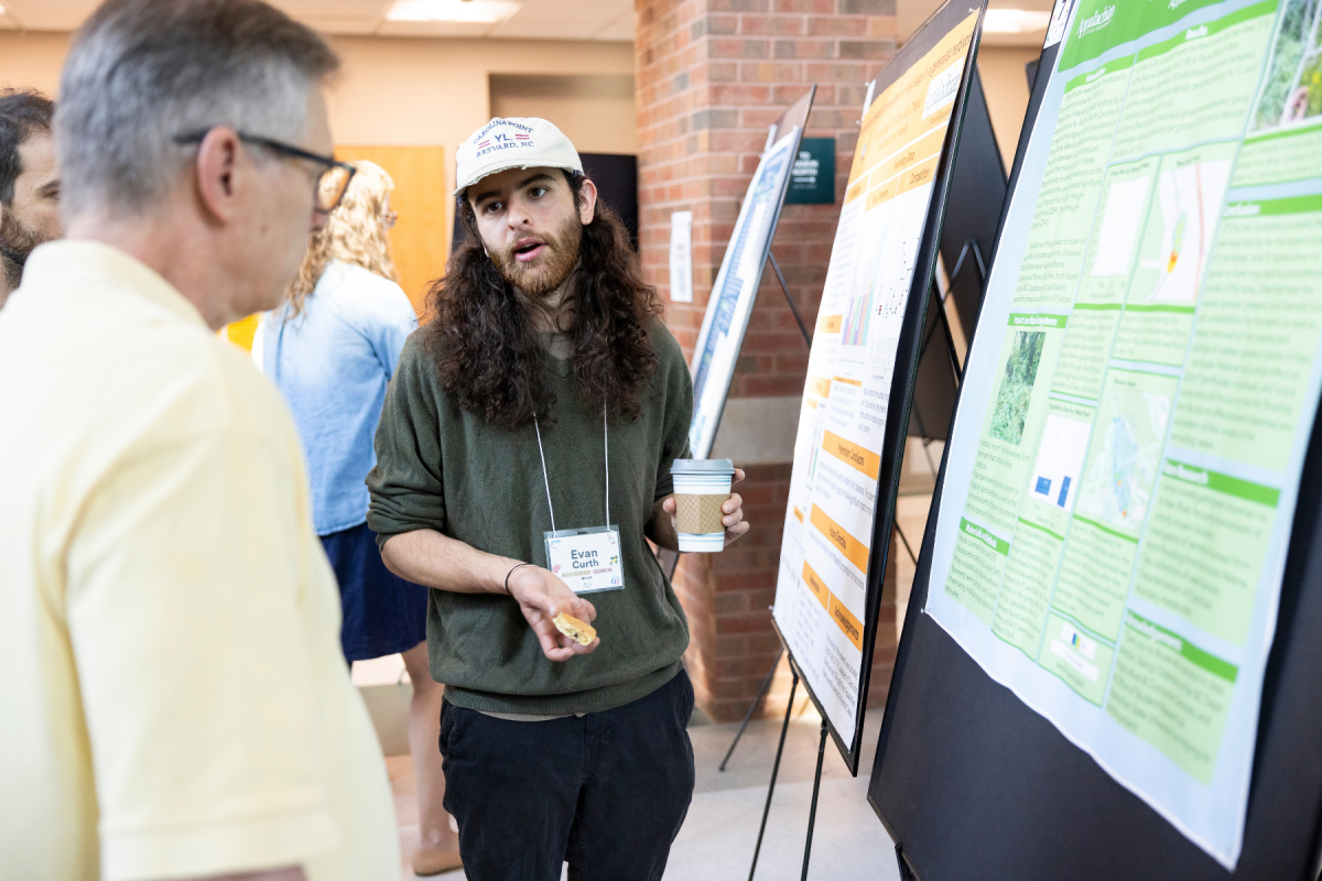 Evan Curth, a graduate student in biology, discusses how introduced weevils work as biocontrol agents against the invasive mile-a-minute weed. Photo by Kyla Willoughby