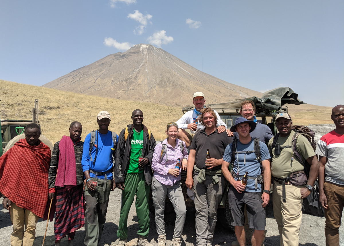 The group is all smiles after the trek as they take a break in front of the active volcano Ol Doinyo Lengai. Photo submitted by Dr. Cynthia Liutkus-Pierce