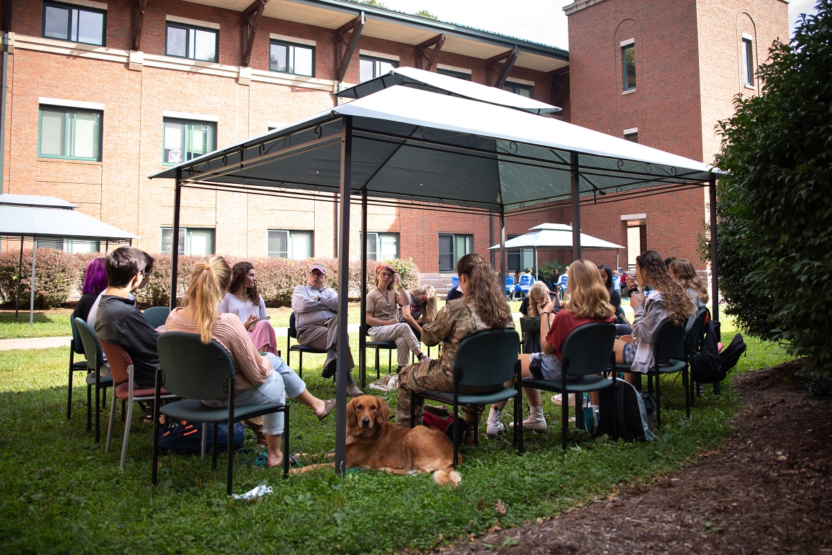 Dr. Clark Maddux, professor in the Department of Interdisciplinary Studies and former director of the Watauga Residential College, leads a seminar in the Living Learning Center's courtyard.