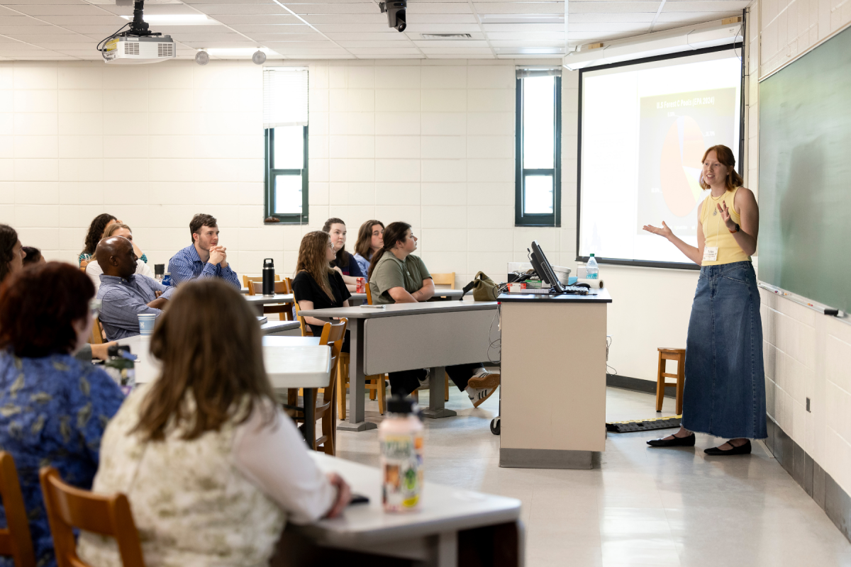 In a lightning talk session at Biology Research Day, graduate student Rylee Strassner explains her carbon storage comparisons between natural successional deciduous forests and planted coniferous forests in the Southern Appalachian Mountains. Photo by Kyla Willoughby