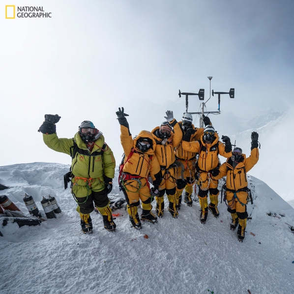 At 8,430 meters above sea level, the high-altitude expedition team celebrates after setting up the world's highest operating automated weather station during the 2019 National Geographic and Rolex Perpetual Planet Everest Expedition. Learn more at www.natgeo.com/everest. Photo by Mark Fisher, National Geographic.