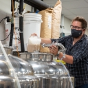 Daniel Parker, operations manager for the fermentation facility and lecturer in the Department of Chemistry and Fermentation Sciences, pitching the yeast into the fermentation tank. Photo by Ellen Gwin Burnette.