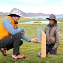 Baker Perry, left, shows Alpaca farmer Don Pedro Godfredo how to take precipitation measurements from his farm, located at an elevation of 16,700 feet near Peru’s Quelccaya Ice Cap. Perry, an assistant professor of geography at Appalachian State University, has received a five-year National Science Foundation grant to expand his research of precipitation and climate change in the Andes Mountains in Peru and Bolivia. (Photo by Dr. Anton Seimon)