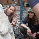 App State environmental science majors Kyia Wing, a senior from Suwanee, Georgia, left, and Kaden Cusack ’25, an App State alumnus from Cary, take a close look at the new boulder donated to the university’s rock garden by Albemarle Corp. Cusak graduated from App State in May, earning his bachelor’s degree in environmental science. Photo by Chase Reynolds