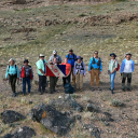 The App State-led Devonian Anoxia, Geochemistry, Geochronology and Extinction Research (DAGGER) group unfurls the National Geographic Explorers Club flag during geology research in Mongolia. Pictured, from left to right, are Dr. Sersmaa Gonchigdorj; Togtokh Javzankhuu; App State Professor Emeritus and adjunct research professor Dr. Johnny Waters; App State professor Dr. Sarah Carmichael; Will Waters (behind Carmichael); Dr. Diana Boyer; Randy Blood; App State senior geology majors Vanya Dill, of Morrisville