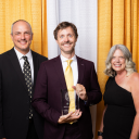 Tommy Guy ’07, center, is the recipient of the 2024 Alumni Award from App State’s College of Arts and Sciences. He is pictured with College of Arts and Sciences Dean Mike Madritch, left, and Associate Vice Chancellor of Alumni Engagement Stephanie Billings ’92 at the 2024 Alumni Awards Gala, held July 13 at App State’s Boone campus. Photo by Chase Reynolds