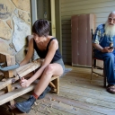 Interviewee Bill Alexander, right, instructs Appalachian State University graduate student Chelsey Johnson, of Knoxville, Tennessee, in how to strip hickory bark for lacing baskets and weaving chair bottoms. Johnson interviewed Alexander for her South Arts-funded grant project documenting living folk traditions in Appalachia. Johnson is an M.A. candidate in Appalachian State University’s Appalachian studies program. Photo by Jesse Barber