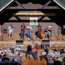 A band competes against more than 100 others in the bluegrass band competition during the 89th Annual Old Fiddler's Convention on Saturday, Aug. 9, 2025, at Felts Park in Galax, Va. Photo by Allison Isley for NPR