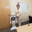 Dr. Yeganeh Madadi (right), assistant professor and director of the Robotics Lab in the Department of Computer Science, with YeRo, a humanoid robot, during the Robotics Lab opening on June 25 in Anne Belk Hall. Photo by Chase Reynolds