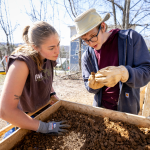 Mary O'Connell (left) and James Moser (right) examine an artifact. Photo by Kyla Willoughby