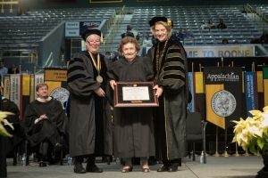 Alma Marsh (center), receives an honorary bachelor’s degree from Dr. Neva Specht (left) and Chancellor Sheri Everts (right), as Chair of Appalachian’s Board of Trustees, James M. Barnes, looks on. Photo by Marie Freeman