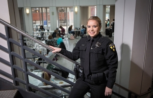 Bryce Helms, a senior criminal justice major and full-time Appalachian police officer, takes a pause from her duties for a photo in the university’s Plemmons Student Union. Photo by Marie Freeman