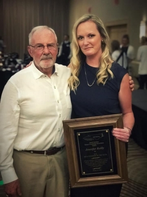 Jenny Reilly receiving the practitioner of the year award, and Dr. Jim Deni who received the liftetime achievement award.