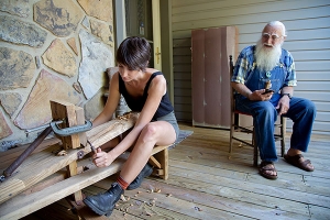 Interviewee Bill Alexander, right, instructs Appalachian State University graduate student Chelsey Johnson, of Knoxville, Tennessee, in how to strip hickory bark for lacing baskets and weaving chair bottoms. Johnson interviewed Alexander for her South Arts-funded grant project documenting living folk traditions in Appalachia. Johnson is an M.A. candidate in Appalachian State University’s Appalachian studies program. Photo by Jesse Barber