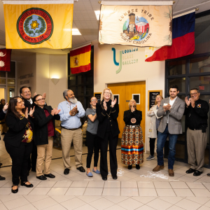 App State Chancellor Sheri Everts, center, and flag ceremony attendees applaud the unfurling of the flag of the Lumbee Tribe of North Carolina in the university’s Plemmons Student Union on Feb. 27. App State first-year student Cierra Bell, immediately to the left of the chancellor, and assistant professor Dr. Seth Grooms, pictured fourth from right, unfurled the flag. Photo by Chase Reynolds