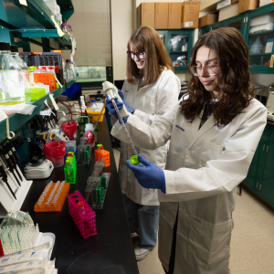 Two students work in a biology lab.