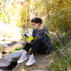 An App State student reads on the banks of Boone Creek in Durham Park, located at App State’s Boone campus. Photo by Chase Reynolds