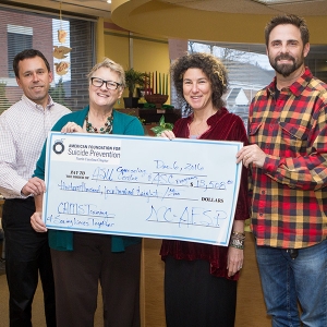 Presenting a check to Appalachian State University from the North Carolina Chapter of the American Foundation for Suicide Prevention (AFSP) is Betsy Rhodes, second from left. With her are, from left, Appalachian’s Dr. Chris Hogan, director of Counseling and Psychological Services, psychologist Dr. Denise Lovin and psychology professor Dr. Kurt Michael. Since the check presentation Dec. 6, the organization has provided an additional gift bringing its support for suicide prevention training at Appalachian to 