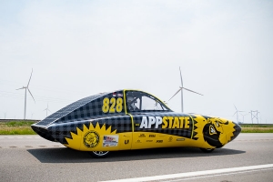 Solar-powered ROSE glides by a wind farm during the first leg of the 2021 American Solar Challenge. Photo by Kyla Willoughby