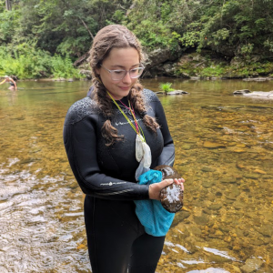 Elijah Thompson, collections manager in App State’s Aquatic Conservation Research Lab, holds a hellbender that was found in the Watauga River. Photo submitted